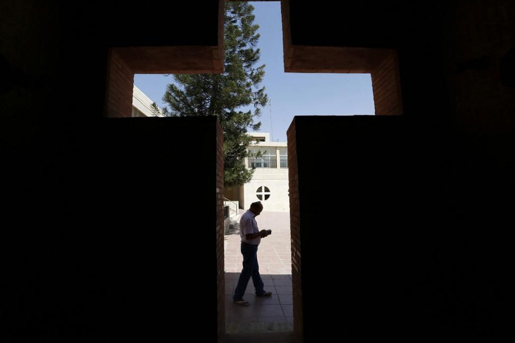 An Iraqi Christian man from Mosul, who fled from violence in their country, reads a book at the Latin Patriarchate Church in Amman