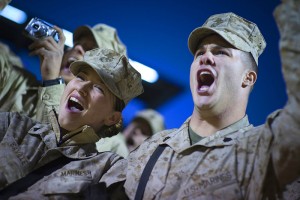 U.S. Marine Corps Cpl. Chantel Saville (left) and Sgt. Jonathan Oaks cheer at the introduction of Grammy award-winning musician Kid Rock and Zac Brown during the 2008 USO Holiday Tour stop at Al Asad Air Base, Iraq, Dec, 19, 2008. (Wikimedia-Commons)